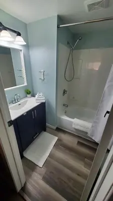 a bathroom with a sink and a shower at Serenity Place by the Lake in Brighton