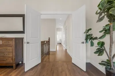 a hallway of a home with white walls and wood floors at Executive 5BR-4BATH Detached Bramp/Miss Border in Brampton