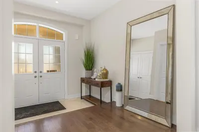 a mirror in a hallway next to a door at Executive 5BR-4BATH Detached Bramp/Miss Border in Brampton