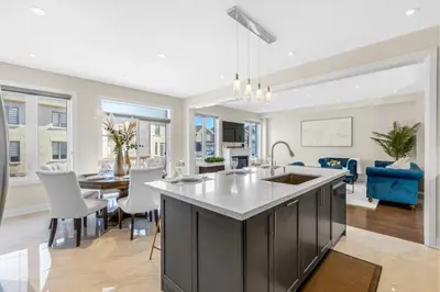 an open kitchen and dining room with a large island at Executive 5BR-4BATH Detached Bramp/Miss Border in Brampton