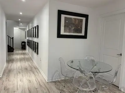 a dining room with a glass table and chairs at Luxury Executive Studio in Oakville