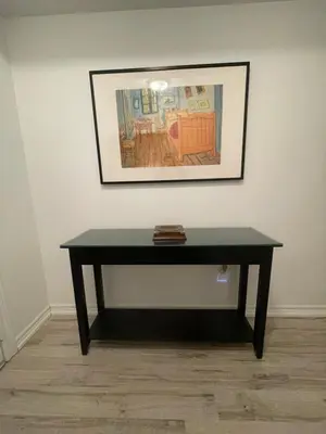 a black table in a room with a picture on the wall at Luxury Executive Studio in Oakville