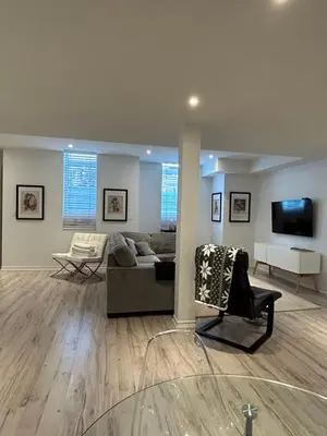 a living room with a couch and a tv at Luxury Executive Studio in Oakville