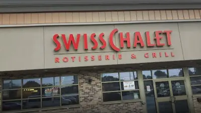 a sign for a swiss chalet restaurant at Executive Room in Toronto next to Yorkdale shopping centre in Toronto