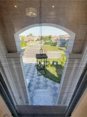 a large window in a house with a chandelier at Executive Room in Toronto next to Yorkdale shopping centre in Toronto