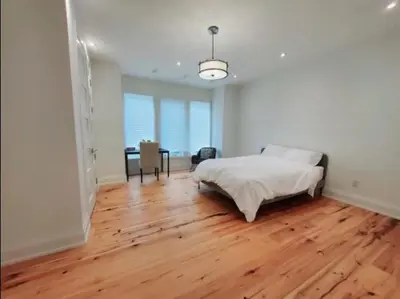 a bedroom with a bed and a wooden floor at Executive Room in Toronto next to Yorkdale shopping centre in Toronto