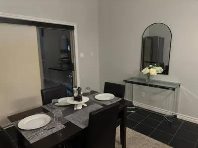 a dining room with a table and a mirror at Luxury Spacious 5-Bedroom Home in London