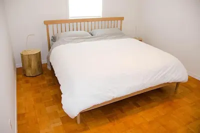 a large white bed in a room with a wooden floor at Heaven on Huycks Bay in Hillier
