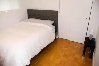 a bedroom with a white bed and a wooden floor at Heaven on Huycks Bay in Hillier