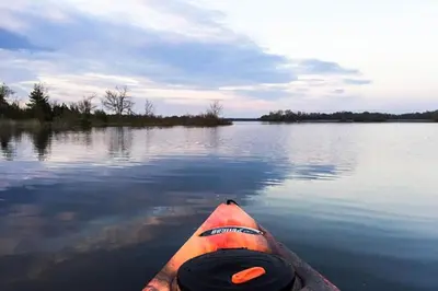 an orange kayak in the water on a lake at Heaven on Huycks Bay in Hillier
