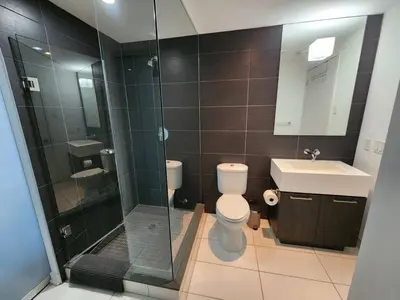 a bathroom with a shower and a toilet and a sink at Chic 1BDR Loft with Office Space-Heart of Toronto in Toronto