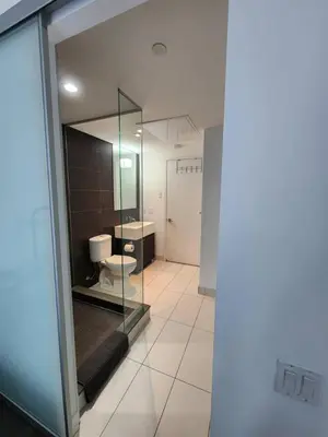a bathroom with a toilet and a glass wall at Chic 1BDR Loft with Office Space-Heart of Toronto in Toronto