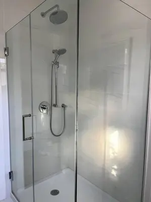 a shower with a glass door in a bathroom at New and Cozy Cottage Minutes to Blue Mountain in Meaford