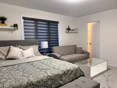 a bedroom with a bed and a couch at Spacious 4-Bedroom Home, Comfortably Sleeps 10 in Barrie