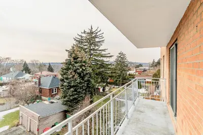 an apartment balcony with a view of the city at Glenview West Apartment w Patio - Near Downtown in Hamilton