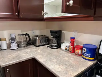 a kitchen counter with a coffee maker and other items on it at Avid vacation palace in Castlemore , Brampton in Brampton