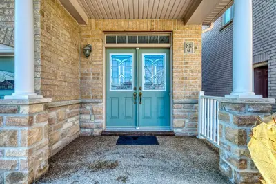 a front door of a brick house with a blue door at Avid vacation palace in Castlemore , Brampton in Brampton