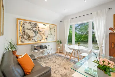 a living room with a couch and a table at Vineyard Villa in Niagara on the Lake