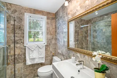 a bathroom with a sink toilet and a mirror at Vineyard Villa in Niagara on the Lake