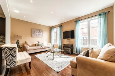 a living room with a couch and a table at 4br Near Hilton Falls - Kelso - Gazebo, Workspace in Milton