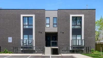 a brick building with two large windows at 2br Boho Townhouse - Walk To Falls, Free Parking in Niagara Falls