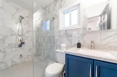 a bathroom with a toilet and a sink and a shower at 2br - Spacious Yard - Canal Bridge, Falls Nearby! in Welland
