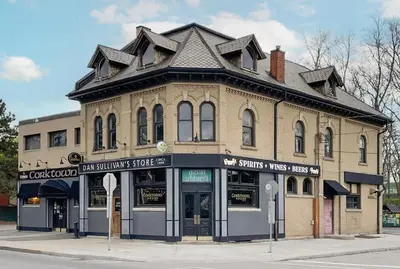 an old building on the corner of a street at Modern Apartment in Corktown Hamilton Sleeps 4 in Hamilton