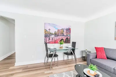 a living room with a table and a couch at Modern Apartment in Corktown Hamilton Sleeps 4 in Hamilton