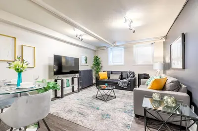 a living room with a couch and a tv at Modern Apartment in a Trendy Neighbourhood in Hamilton