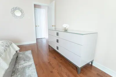 a bedroom with a white dresser with a drawer at Main Floor Luxury Apartment in Vaughan