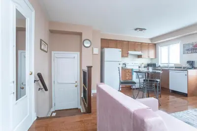a kitchen with a white refrigerator and a table at Main Floor Luxury Apartment in Vaughan
