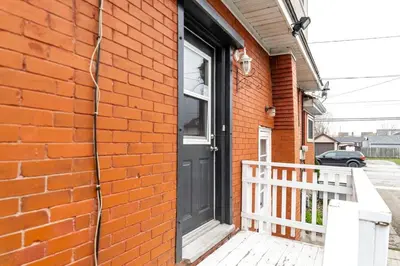a black door on a brick building with a porch at 2br, Welland Canal, Near Merritt, 20 Min To Falls in Welland