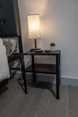 a table with a lamp on it next to a bed at SHORE VISTA LODGE in Georgina