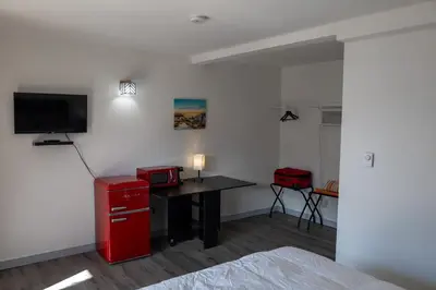a room with a desk and a tv on a wall at SHORE VISTA LODGE in Georgina