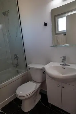 a bathroom with a toilet and a sink and a shower at SHORE VISTA LODGE in Georgina