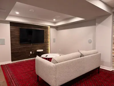 a living room with a couch and a flat screen tv at Spacious Bottom-Floor 2BR Suite in Innisfil