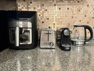 a counter top with a coffee maker and a toaster at Spacious Bottom-Floor 2BR Suite in Innisfil
