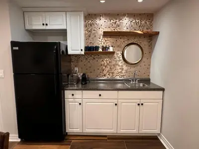 a kitchen with a black refrigerator and a sink at Spacious Bottom-Floor 2BR Suite in Innisfil
