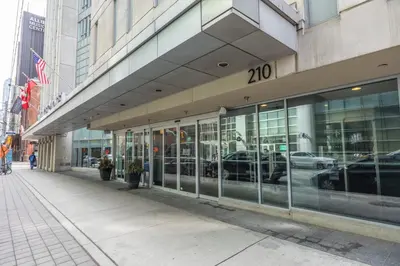 a building on a city street with cars in the windows at Modern 2-Bedroom Condo w Floor to Ceiling Windows in Toronto