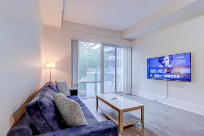 a living room with a couch and a tv at Metropolis Loft - CN Tower in Toronto