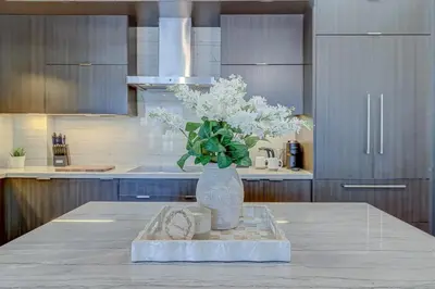 a vase with flowers on a table in a kitchen at Metropolis Loft - CN Tower in Toronto