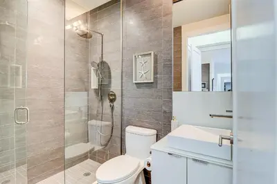 a bathroom with a toilet and a shower at Metropolis Loft - CN Tower in Toronto