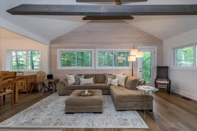 a living room with a couch and a table at Gorgeous Muskokan Cottage on Six Mile Lake in Port Severn