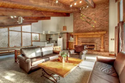 a living room with leather furniture and a fireplace at 8 bdrm Blue Mountain Cottage, Large Groups, Private Beach Access, Hot Tub, Sauna, Ping Pong Table Perfect for Large Groups, Petfriendly in Blue Mountains