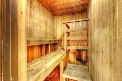 an empty wooden sauna with a bench in it at 8 bdrm Blue Mountain Cottage, Large Groups, Private Beach Access, Hot Tub, Sauna, Ping Pong Table Perfect for Large Groups, Petfriendly in Blue Mountains