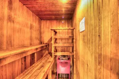 a wooden sauna with wooden walls and wooden shelves at 6 bdrm Blue Mountain Cottage, Private Beach Access, Hot Tub, Sauna, Table Tennis, BBQ, Petfriendly in Blue Mountains