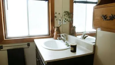 a bathroom with a white sink and a mirror at 4 Bedroom Condo at Tyrolean at Blue Mountain in Blue Mountains