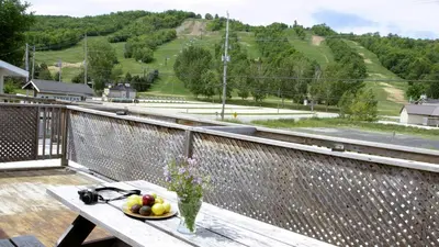 a bowl of fruit on a table on a balcony at 4 Bedroom Condo at Tyrolean at Blue Mountain in Blue Mountains
