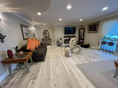 a living room with a couch and a tv at Khan’s Resort in Cobourg