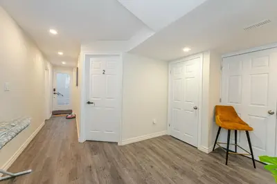 a room with white doors and a stool in it at Cozy basement suites Oakville in Oakville
